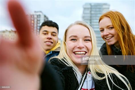 Stock Photo Three Teenagers Taking A Selfie On Their Mobile Phone Taken From The Phone S