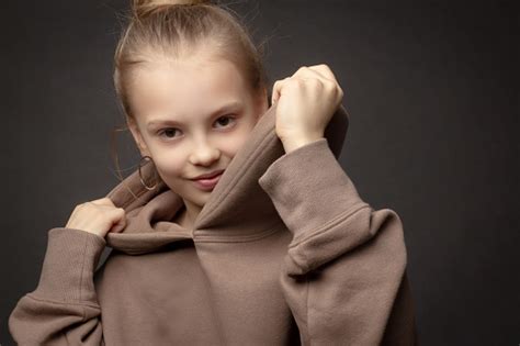 Hildgirl With Long Hair Gathered In A Bun Stock Photo Download Image