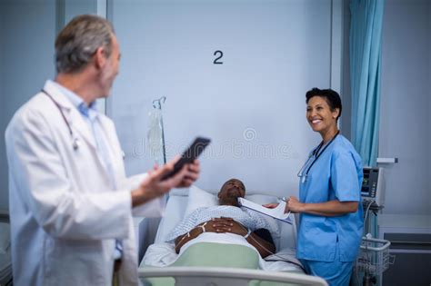 Doctor Interacting With Nurse In Ward Stock Photo Image Of Mature