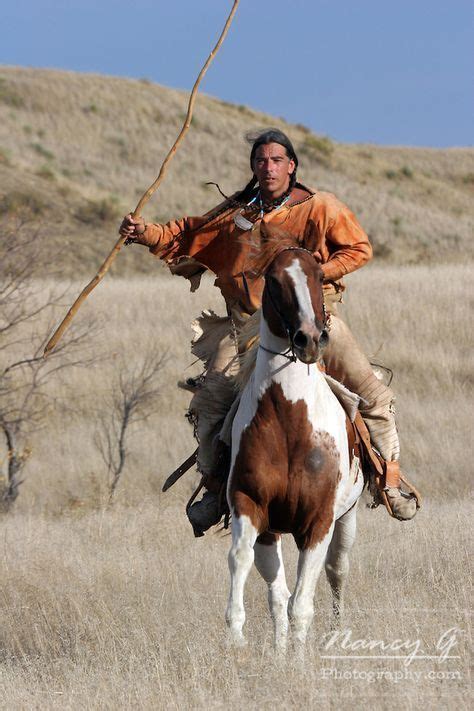 A Native American Lakota Sioux Riding Horseback On The Prairie Of South