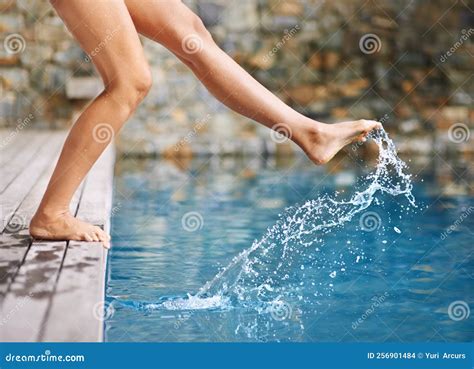 Getting A Feel For The Water A Womans Foot In The Swimming Pool Stock