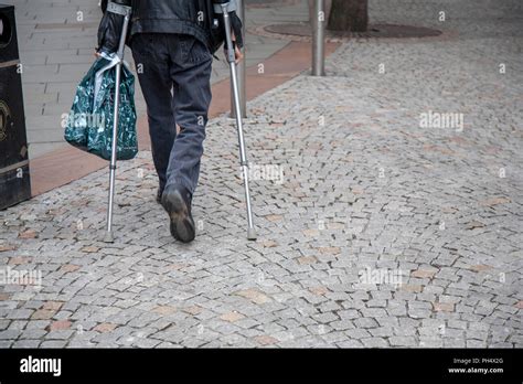 Cropped Image Of A Man On Crutches Taken From Behind Stock Photo Alamy