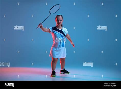 Action Beautiful Dwarf Woman Practicing In Badminton Isolated On Blue Background In Neon Light