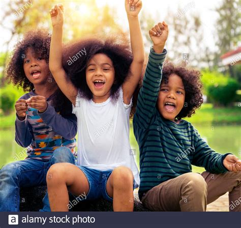 Happy African American Boy And Girl Kids Group Playing In The