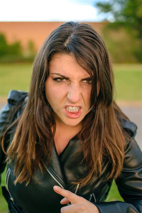 Young Woman Very Angry With Aggressive Face And Pointing With Finger