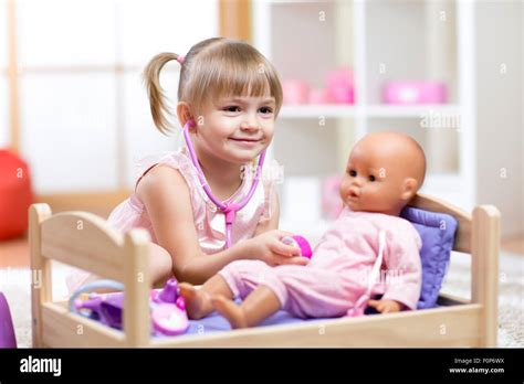 Child Playing With Doll Hi Res Stock Photography And Images Alamy