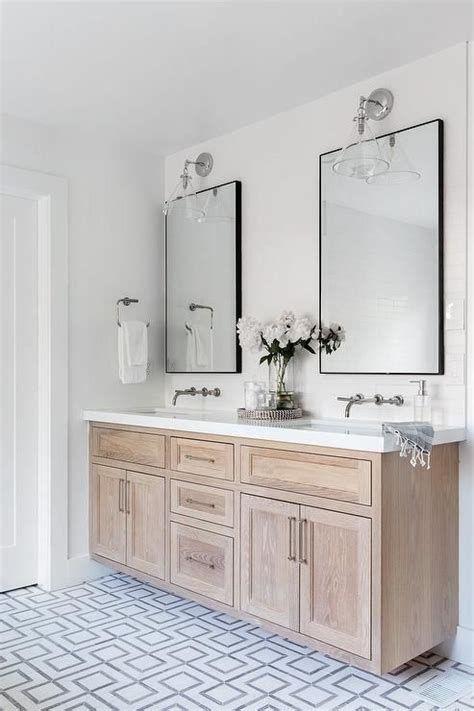 A Brushed Oak Dual Bath Vanity Sits On White And Gray Geometric Floor