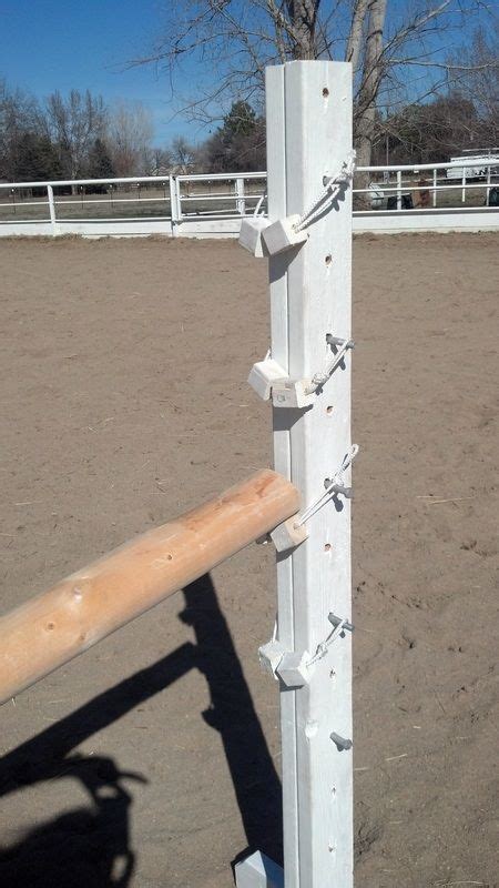 A White Pole With Several Pieces Of Wood Attached To It In The Middle