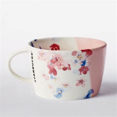 A Ceramic Mug With Floral Art And Asymmetrical Dipped Pink Glaze Part