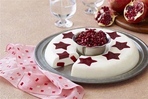 Pomegranates Are Placed On Top Of The Cake And Garnished With Red Stars
