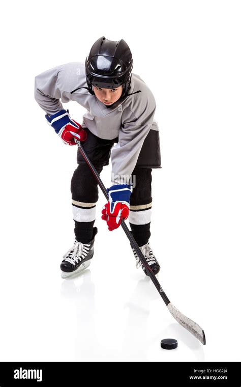 Junior Ice Hockey Player With Full Equipment And Uniform Posing For A