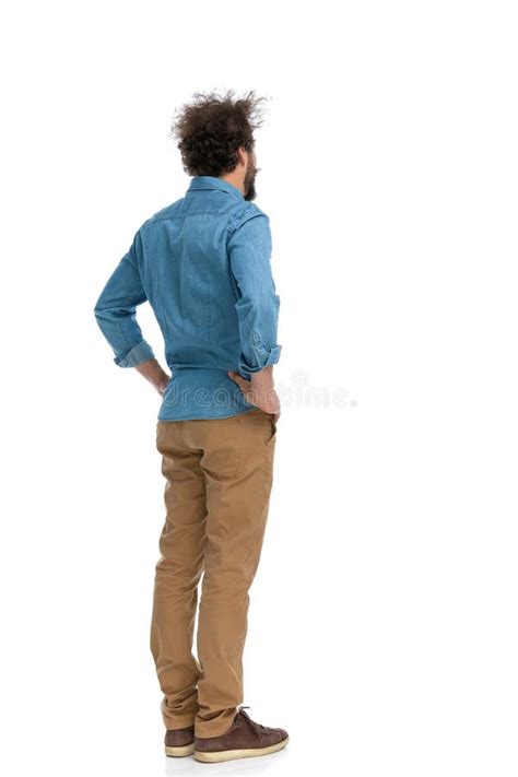 Casual Man Holding Hands On His Hips And Pondering Stock Photo Image