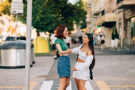 Happy Meeting Of Two Friends Hugging In The Street Stock Photo Image