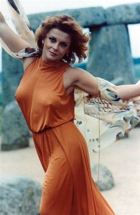 A Woman In An Orange Dress Posing For A Photo