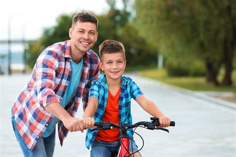 Dad Teaching Son To Ride Bicycle Stock Photo Image Of Drive Bike