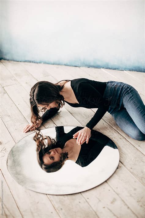 Woman Lying On Floor With Round Mirror Del Colaborador De Stocksy