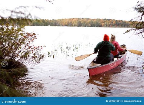 People Are Canoeing On A Peaceful Body Of Water Stock Image Image Of