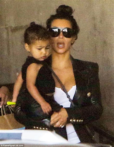North West Mimics Kim Kardashians Facial Expression And Stylish Topknot Daily Mail Online