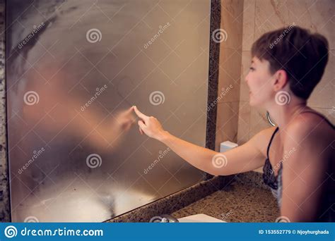 A Woman Draws A Heart In The Mirror The Heart Is Fingerprinted On The Glass In Bathroom People
