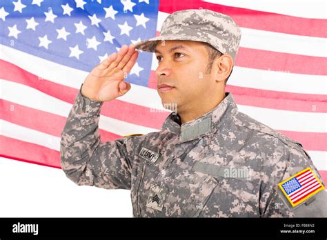 Portrait Of American Soldier Saluting On Us Flag Background Stock Photo