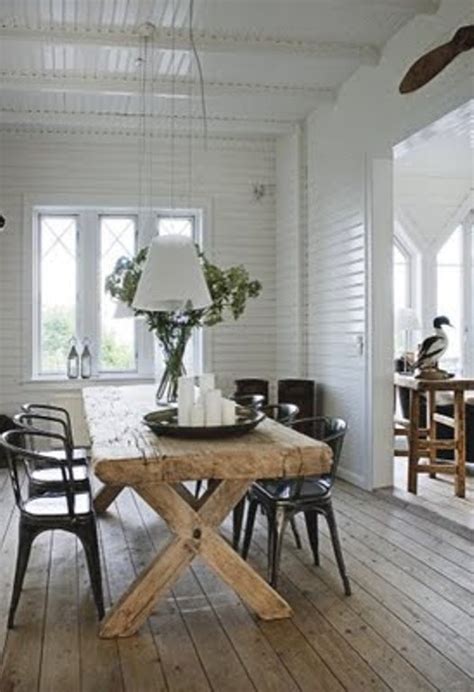 One such combination is a farmhouse dining room table paired with modern chairs. Summer House Decorated With Rough Wooden Furniture - DigsDigs