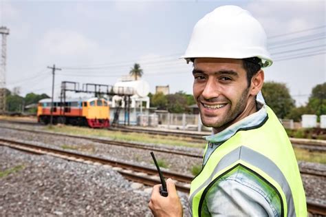 Premium Photo Portrait Of Smiling Man Standing On Railroad Track