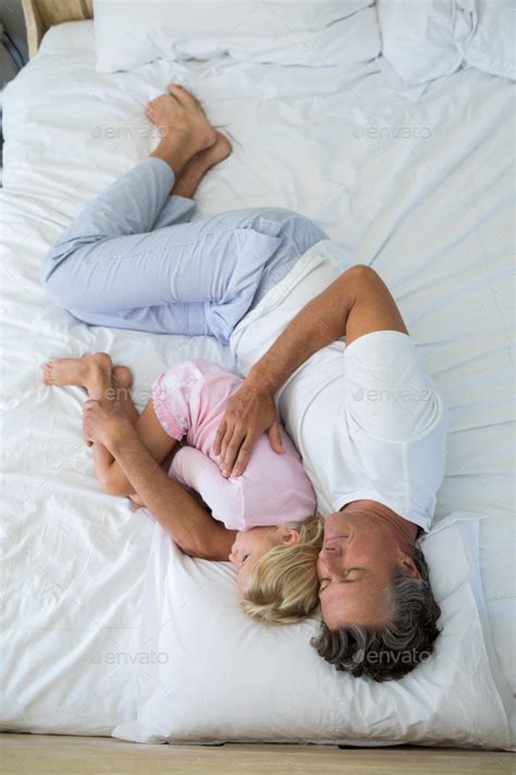 Father And Babe Sleeping Together On Bed In Bedroom Stock Photo By