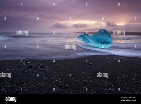 Translucent Blue Iceberg Washed Ashore On Breidamerkursandur Black