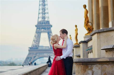 Couple Kissing In Front Of The Eiffel Tower In Paris France Stock
