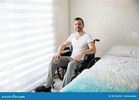 Paralyzed Man On A Wheelchair At Home Stock Photo Image Of Young