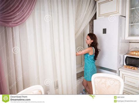 Young Woman Looking Out Kitchen Window Stock Photo Image
