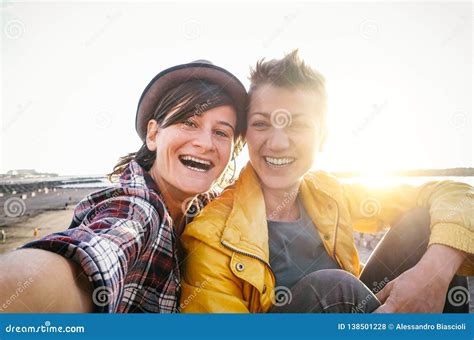 Happy Gay Couple Taking Selfie On The Beach At Sunset Young Lesbians Having Fun Dating First