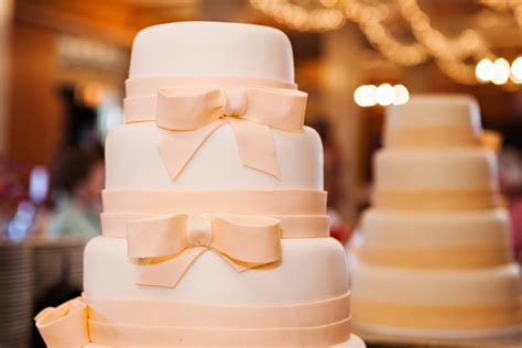 Ivory And Pastel Peach Wedding Cake With Ribbon Bows Design