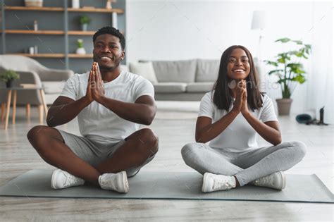 Black Couple Meditating Keeping Hands Together In Prayer Pose Stock