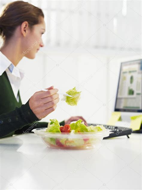 Businesswoman Eating Salad — Stock Photo © Diegocervo 9298691