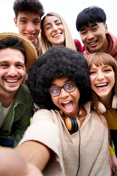Vertical Photo Of Cheerful Group Of Friends Taking Smiling Selfie