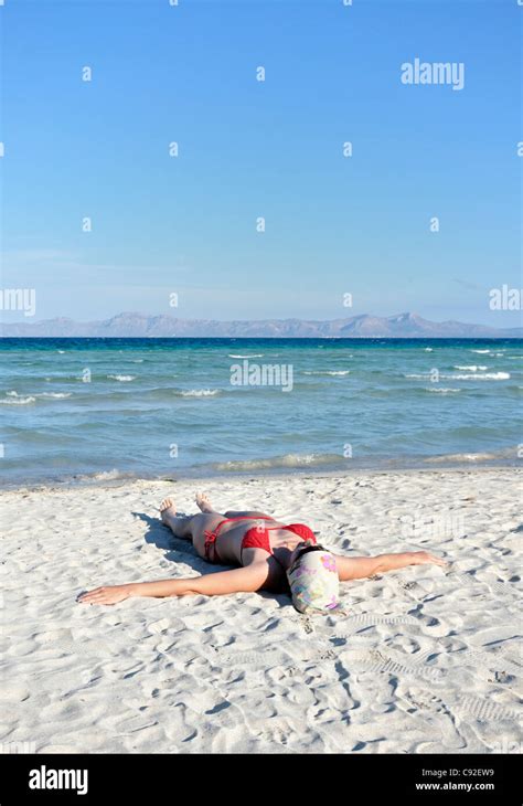 Mid Adult Woman Sunbathing On Beach Alcudia Mallorca Spain Europe