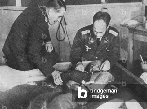 Nazi Physicians Performing Freezing Experiments On An Internee At Dachau Concentration Camp C