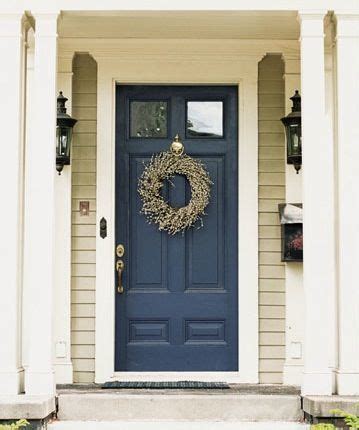 Install exterior black shutters to unite complementary house colors. Navy blue front door on a tan house with white trim ...