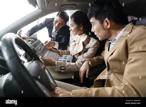 Car salesmen and young couples Stock Photo - Alamy