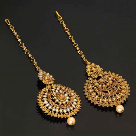 This large maang tikka is a gorgeous example of how you can wear large jewellery pieces without feeling lost. Gold maang tikka - Jaipur Mart - 2755920