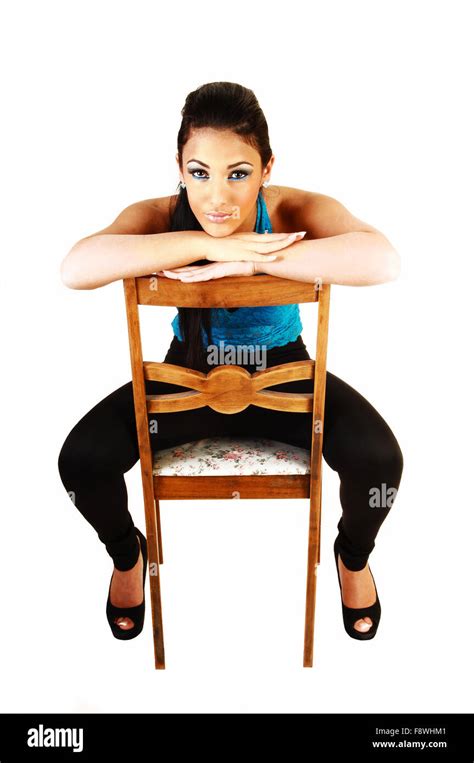 A Young Teenage Girl Sitting Backwards On A Chair In A Blue Corset And