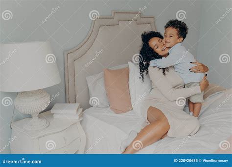 Cute Little Son Hugging His Pregnant Mom Waiting For Future Brother Or Sister Stock Image