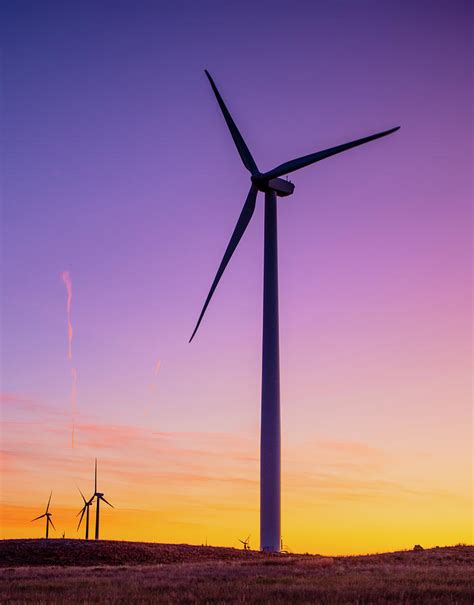 Wind Turbines In Field Against Sunset Sky Photograph By Cavan Images