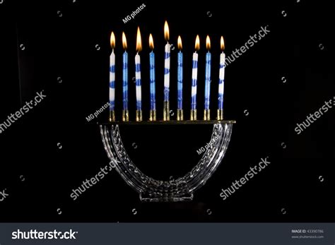 Crystal Menorah With All The Candles Lit On A Black Background Stock