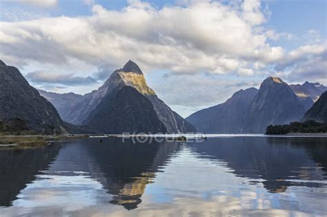 New Zealand Scenic View Of Mountains Reflecting On Shiny Surface Of