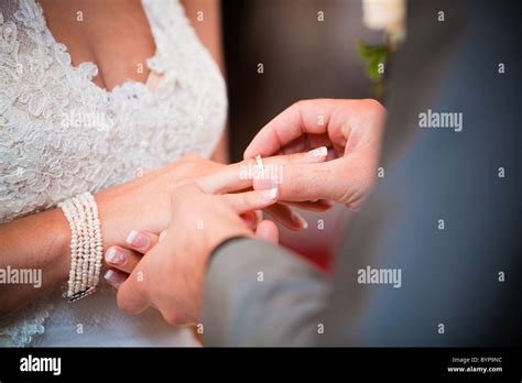 Bride And Groom Putting On The Wedding Ring On Their Wedding Ceremony Stock Photo Alamy