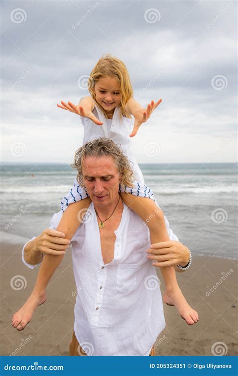 Daughter Sitting On Father`s Shoulders Father And Daughter Playing Together At The Beach Happy