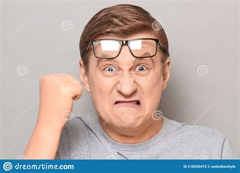 Portrait Of Angry Annoyed Man Shaking Fist In Threatening Gesture Stock