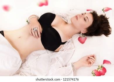 Attractive Sexual Brunette Sleeping On Bed Stock Photo